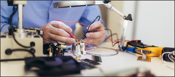 Technician working on-site with specialized tools, installing and setting up medical equipment. The image highlights professional on-site installation support, ensuring proper setup and optimal functioning of the equipment through technician dispatch and equipment commissioning